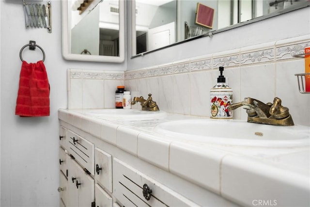 bathroom featuring a sink and double vanity