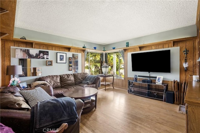 living room with a textured ceiling and wood finished floors