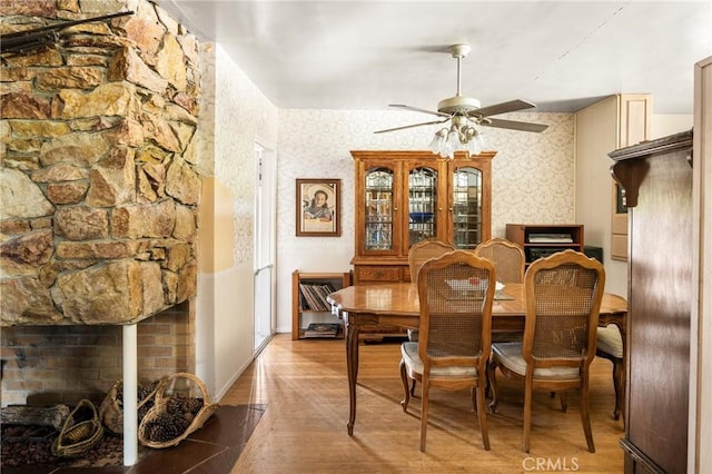 dining space with ceiling fan and wood finished floors