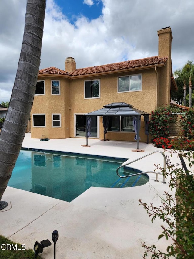 outdoor pool with a gazebo and a patio