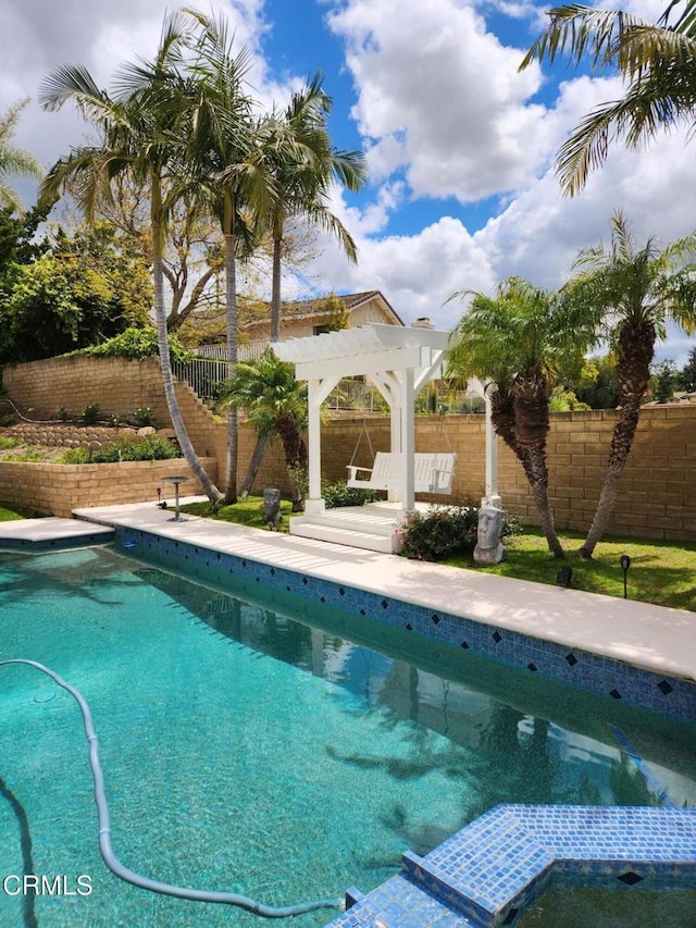 view of swimming pool with a fenced backyard, a gazebo, and a pool with connected hot tub