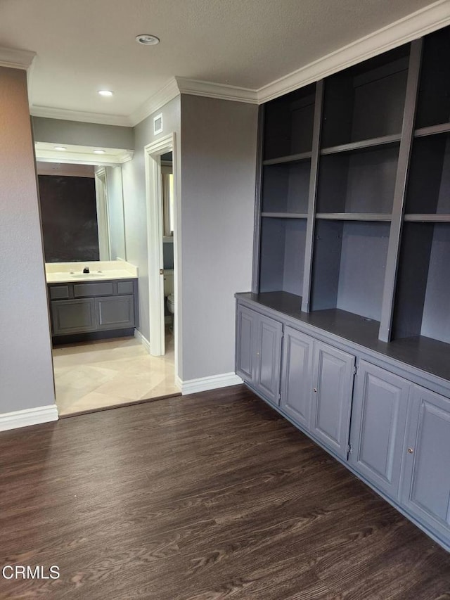 interior space with visible vents, crown molding, wood finished floors, baseboards, and recessed lighting