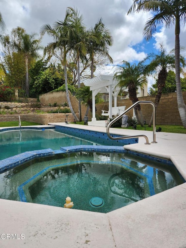 view of pool with fence, a sink, a pergola, and a pool with connected hot tub