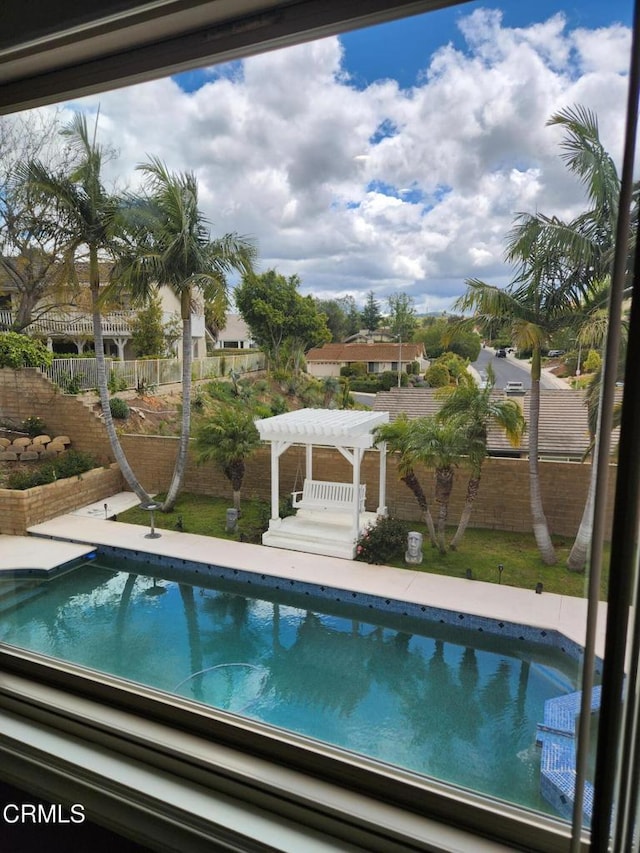 outdoor pool featuring a fenced backyard and a pergola