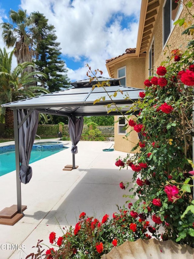 pool with a gazebo and a patio