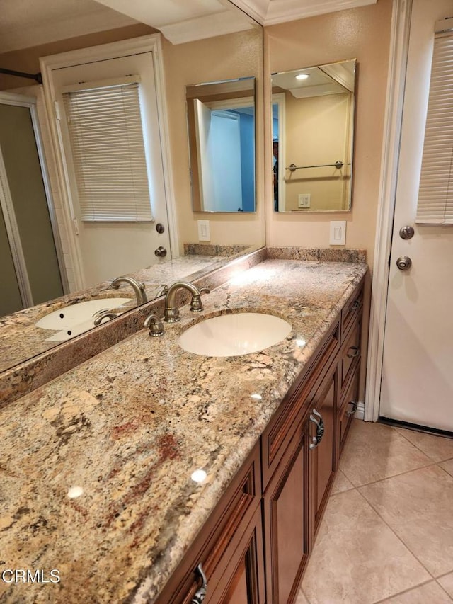 bathroom with crown molding, tile patterned floors, and vanity