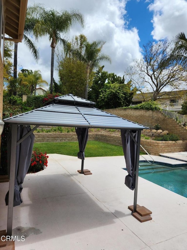 view of pool featuring a gazebo, a patio area, fence, and a fenced in pool