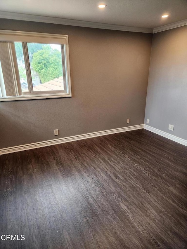 empty room featuring recessed lighting, baseboards, ornamental molding, and dark wood-style flooring