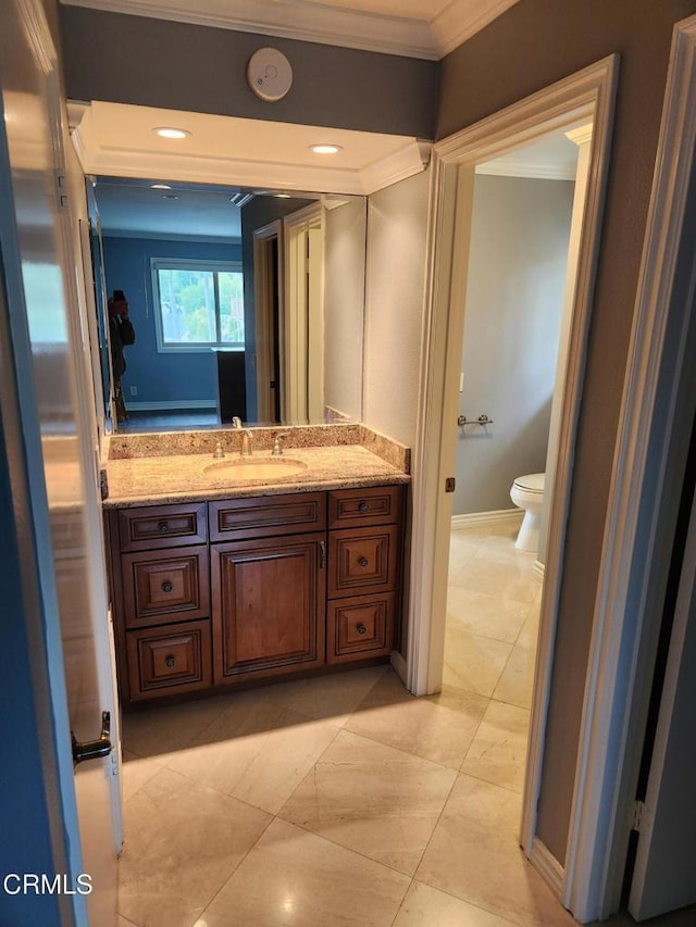 half bathroom featuring crown molding, toilet, and vanity