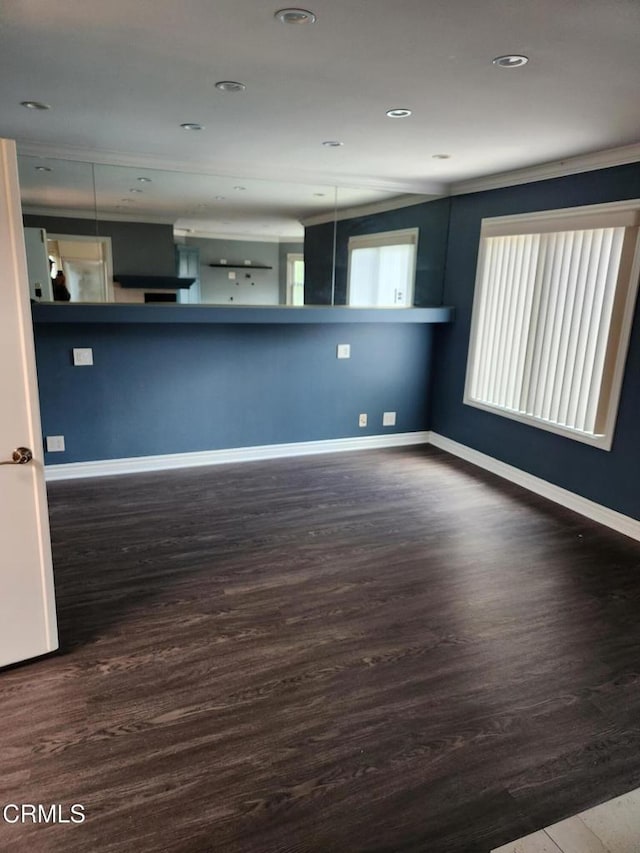 unfurnished living room with baseboards, recessed lighting, and wood finished floors