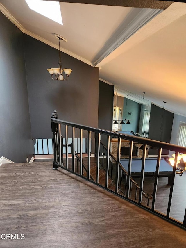 hallway with crown molding, a chandelier, an upstairs landing, and wood finished floors
