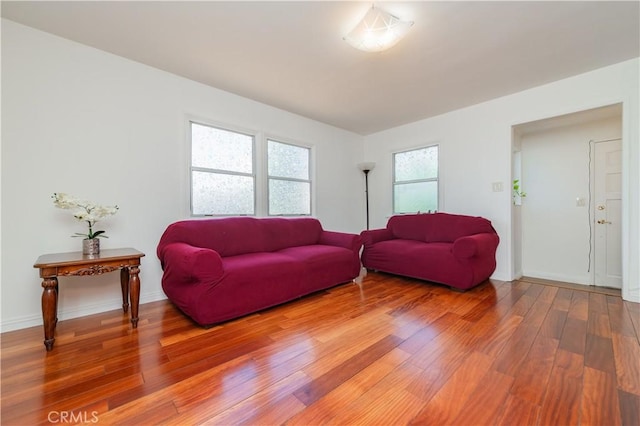 living room with baseboards and light wood-style flooring