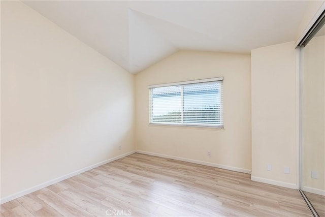 30902 Clubhouse Dr Unit 24E, Laguna Niguel, CA 92677 - empty room with light wood finished floors, lofted ceiling, and baseboards