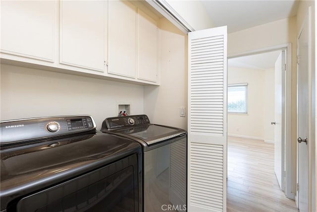 30902 Clubhouse Dr Unit 24E, Laguna Niguel, CA 92677 - laundry area featuring cabinet space, washing machine and clothes dryer, light wood finished floors, and baseboards