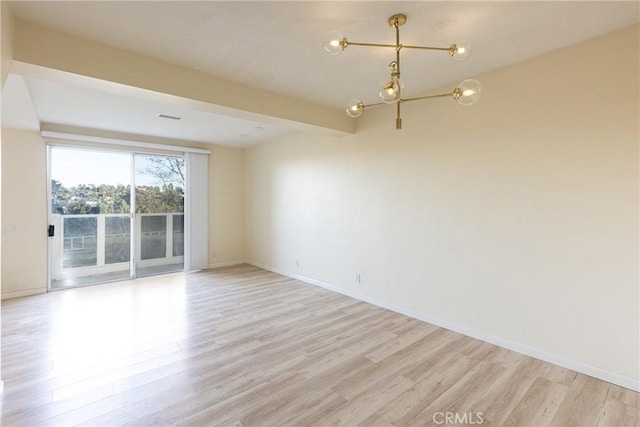 30902 Clubhouse Dr Unit 24E, Laguna Niguel, CA 92677 - unfurnished room featuring light wood-type flooring, a chandelier, and baseboards