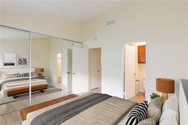 30902 Clubhouse Dr Unit 24E, Laguna Niguel, CA 92677 - bedroom featuring a closet, high vaulted ceiling, light wood-style flooring, and connected bathroom