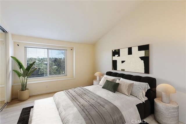 30902 Clubhouse Dr Unit 24E, Laguna Niguel, CA 92677 - bedroom with light wood-type flooring and vaulted ceiling