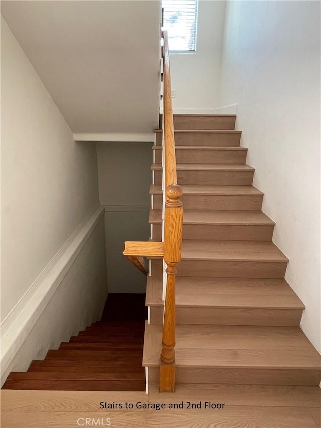 stairway with wood finished floors