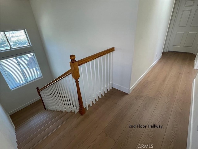 stairs featuring baseboards and wood finished floors