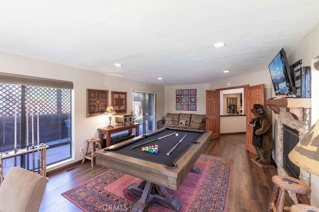 game room featuring pool table, a textured ceiling, recessed lighting, and dark wood-type flooring