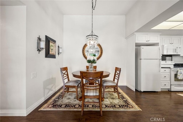 40N Calle Aragon, Laguna Woods, CA 92637 - dining space featuring an inviting chandelier, baseboards, and dark wood-style floors