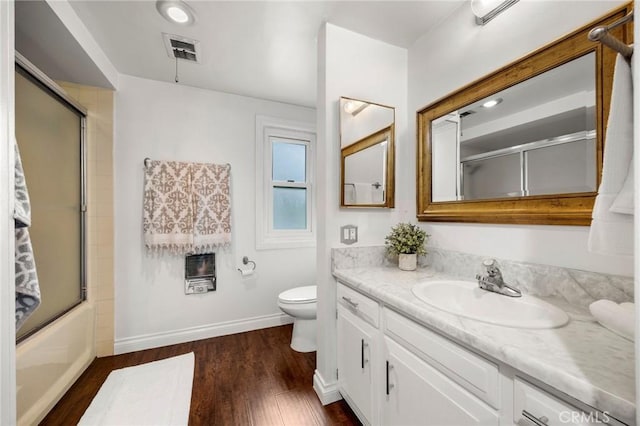 40N Calle Aragon, Laguna Woods, CA 92637 - full bathroom with visible vents, wood finished floors, vanity, baseboards, and toilet