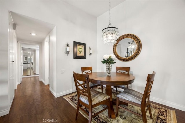 40N Calle Aragon, Laguna Woods, CA 92637 - dining area featuring baseboards, dark wood-style floors, and a chandelier