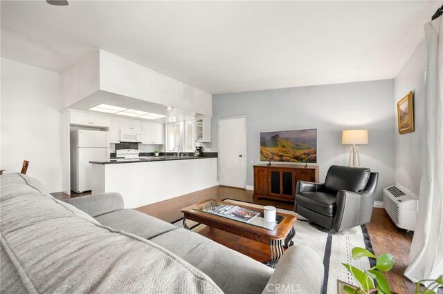 40N Calle Aragon, Laguna Woods, CA 92637 - living area featuring baseboards and wood finished floors