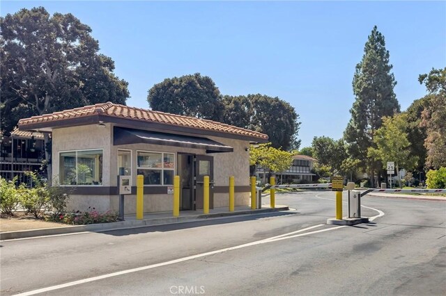 40N Calle Aragon, Laguna Woods, CA 92637 - view of road with a gated entry, traffic signs, and curbs