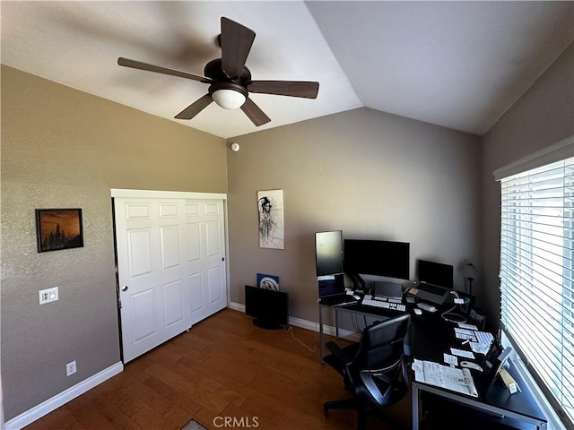 office area featuring a ceiling fan, baseboards, wood finished floors, and lofted ceiling