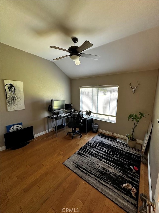office area featuring baseboards, a ceiling fan, wood finished floors, and lofted ceiling