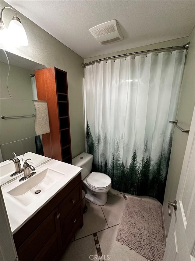 full bathroom with visible vents, tile patterned flooring, vanity, toilet, and a textured ceiling