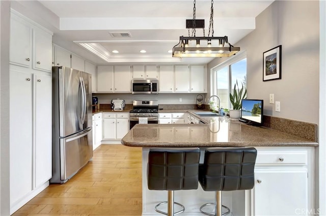 3 Holly Hill Ln, Laguna Hills, CA 92653 - kitchen featuring stainless steel appliances, a sink, a peninsula, white cabinets, and recessed lighting