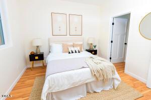 bedroom featuring light wood-type flooring and baseboards
