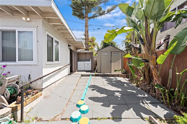 202 Avenida Monterey, San Clemente, CA 92672 - view of home's exterior featuring washing machine and clothes dryer, a shed, a fenced backyard, an outbuilding, and a patio area