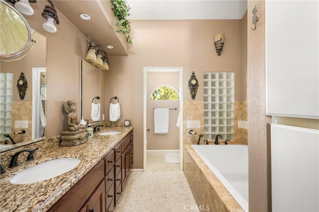401 E Yale Loop Unit 20, Irvine, CA 92614 - full bathroom featuring a bath, baseboards, and double vanity