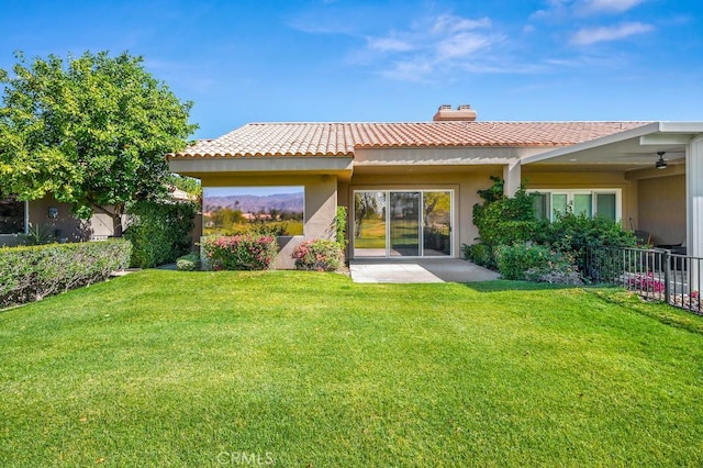 53 Pine Valley Dr, Rancho Mirage, CA 92270 - rear view of property with a tile roof, stucco siding, a yard, and a chimney