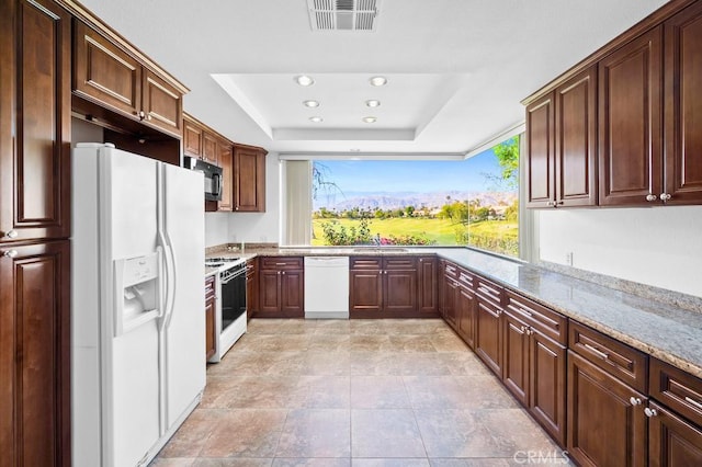53 Pine Valley Dr, Rancho Mirage, CA 92270 - kitchen featuring a healthy amount of sunlight, visible vents, a sink, a raised ceiling, and white appliances