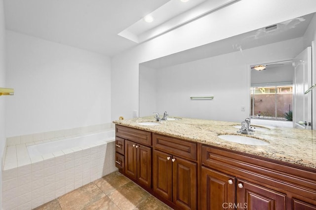 53 Pine Valley Dr, Rancho Mirage, CA 92270 - full bathroom featuring a sink, a relaxing tiled tub, double vanity, and visible vents