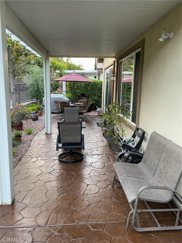view of patio featuring fence and outdoor dining space