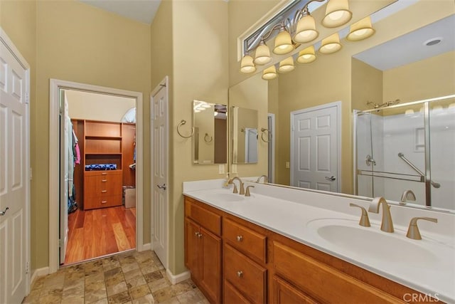 9169 Wooded Hill Dr, Corona, CA 92883 - full bath with baseboards, a sink, a stall shower, and double vanity