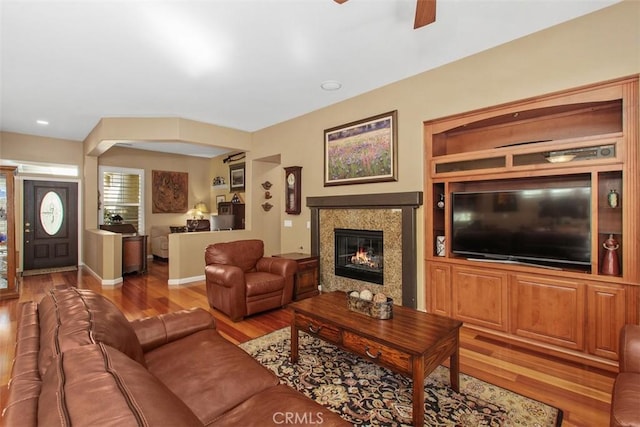 9169 Wooded Hill Dr, Corona, CA 92883 - living room featuring a ceiling fan, baseboards, a glass covered fireplace, and wood finished floors