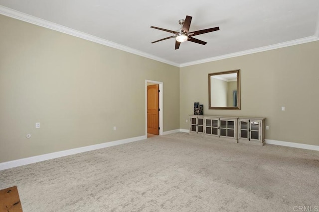 unfurnished room featuring carpet flooring, ceiling fan, ornamental molding, and baseboards