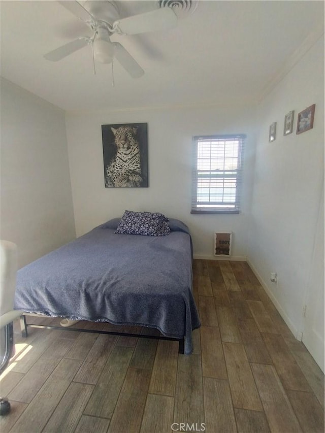 bedroom with baseboards, a ceiling fan, and wood finished floors