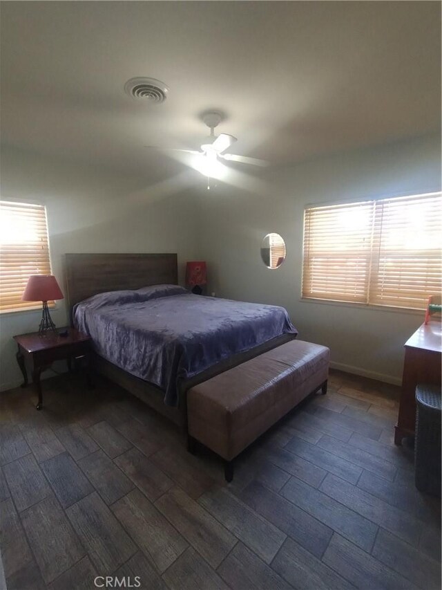 bedroom featuring wood tiled floor, a ceiling fan, and visible vents
