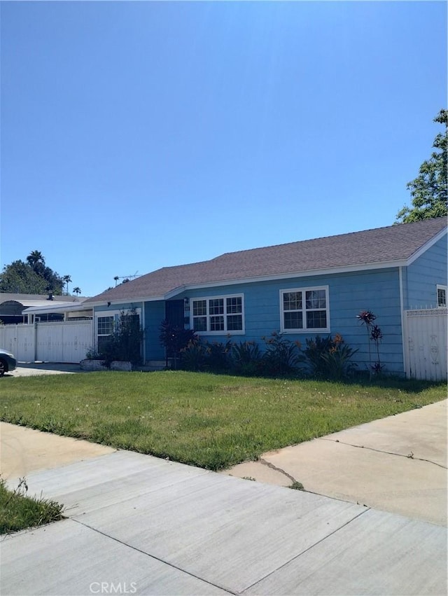 ranch-style home with fence and a front lawn