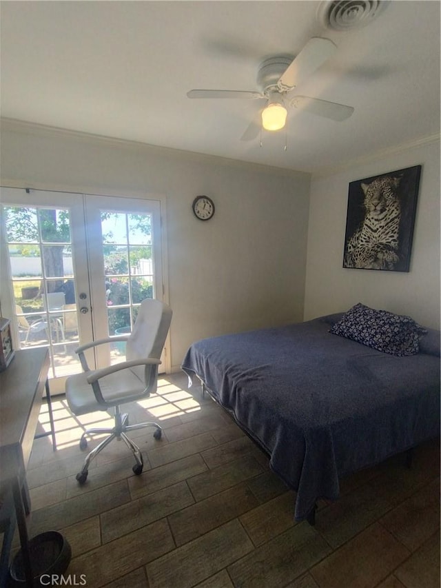 bedroom featuring visible vents, ornamental molding, wood finished floors, access to outside, and a ceiling fan
