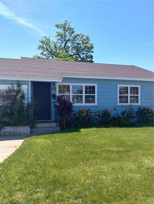 ranch-style house with a front lawn
