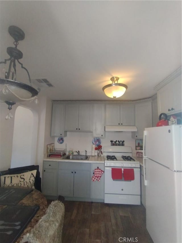 3620 Hoover St, Riverside, CA 92504 - kitchen featuring white appliances, a sink, dark wood-style floors, under cabinet range hood, and arched walkways