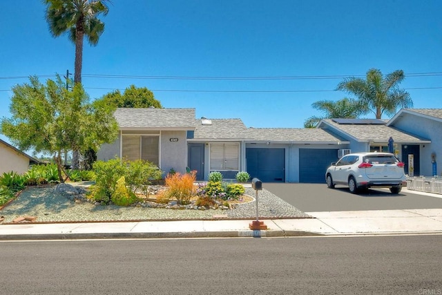 4549 Quailridge Dr, Oceanside, CA 92056 - single story home featuring an attached garage, driveway, solar panels, stucco siding, and roof with shingles